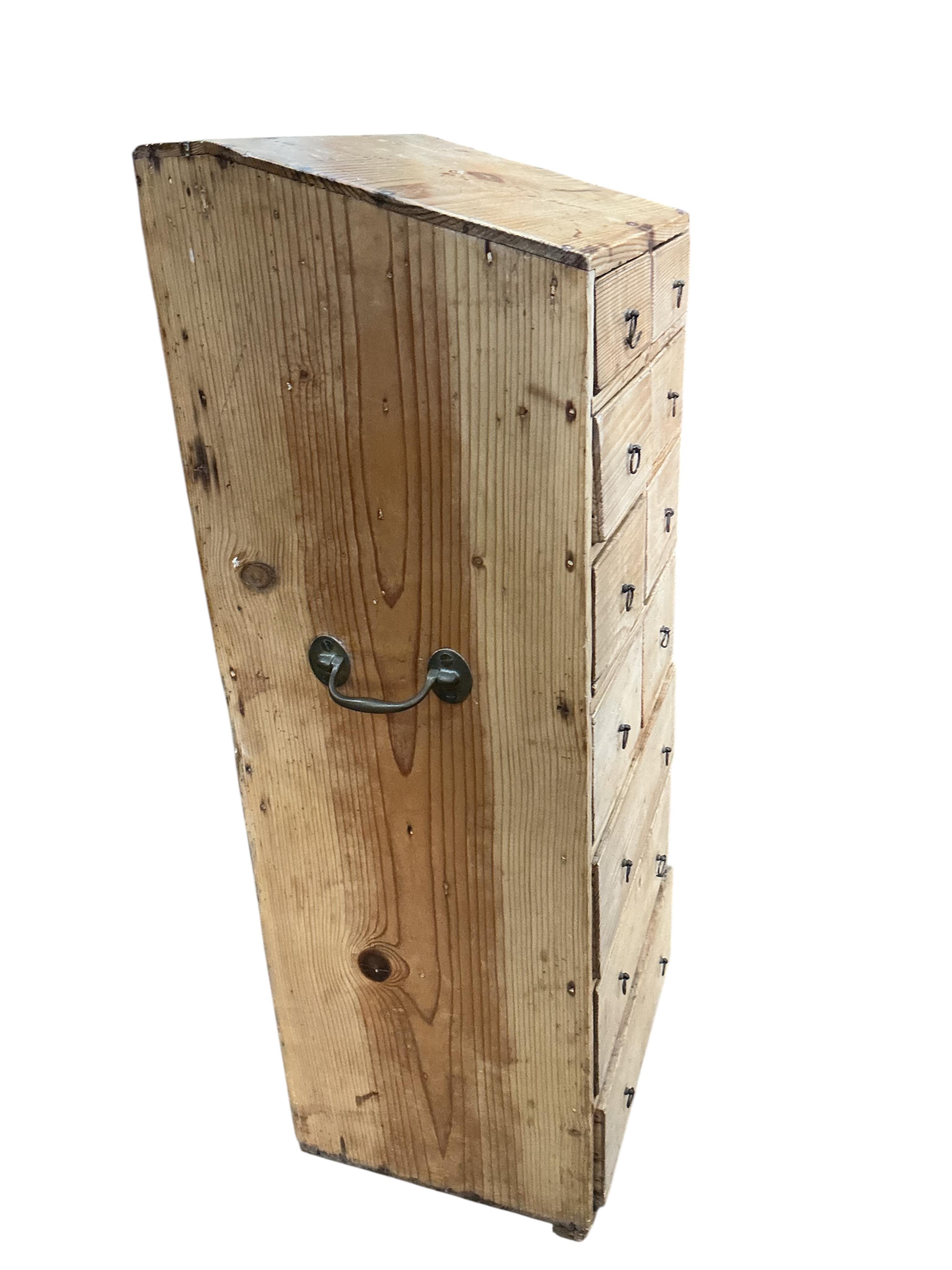 An early 19th century pine eleven drawer campaign chest with slant top, width 33cm, depth 26cm, height 80cm